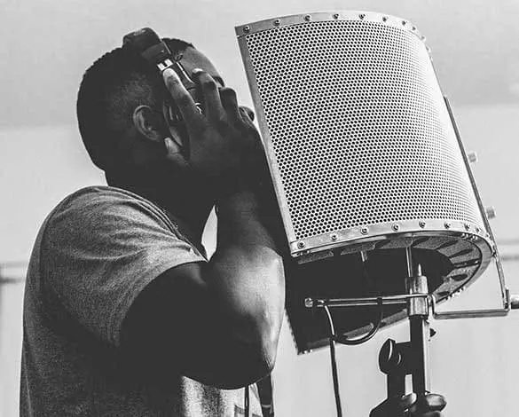Vocalist recording with a studio microphone